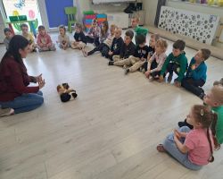 dzieci podczas spotkania z żywymi zwierzętami kangurem, agamom, królikiem