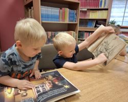 dzieci podczas zajęć czytelniczych w bibliotece