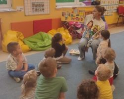 dzieci i rodzice podczas głośnego czytania literatury dziecięcej