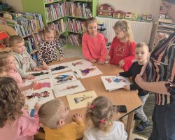 dzieci i bibliotekarka podczas zajęć w bibliotece