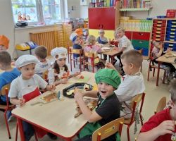 dzieci podczas wykonywania owocowych szaszłyków