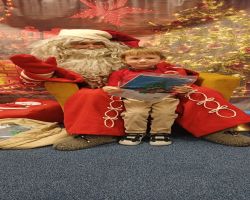 dzieci podczas spotkania ze Świętym Mikołajem i Panią Mikołajową, otrzymują prezenty i śpiewają piosenki