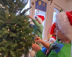 Dzieci ubierają choinkę na święta