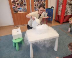 Dzieci uczestniczą w zajęciach poświęconych eksperymentom z suchym lodem