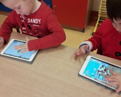 dzieci wykonujące zadania na tabletach